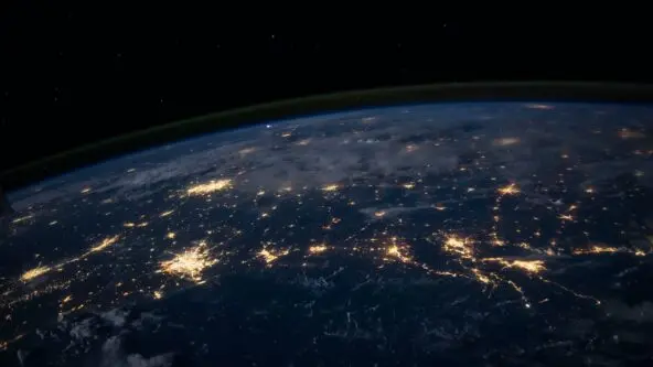 photo of earth from space; urban areas appear as clusters of light where data illuminates decisions