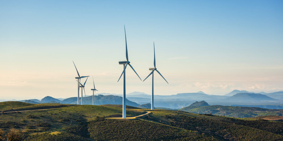 photo wind farm five wind turbines atop a mountain for renewable energy production