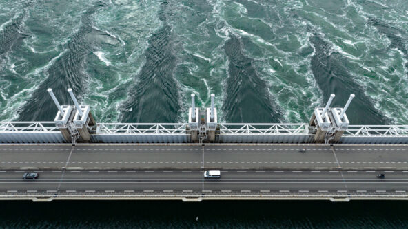 aerial photo of a service road over a dam / hydroelectric power plant