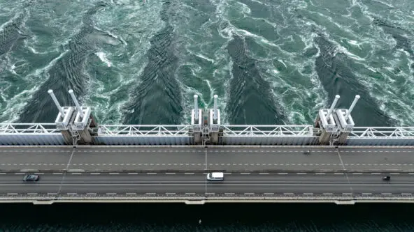 aerial photo of a service road over dam / hydroelectric power plant