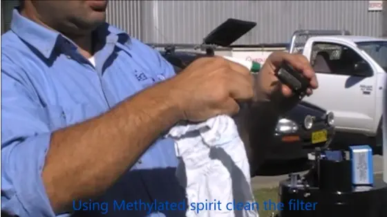photo of tipping bucket maintenance: spray siphon with isopropyl alcohol to clean the finger filter