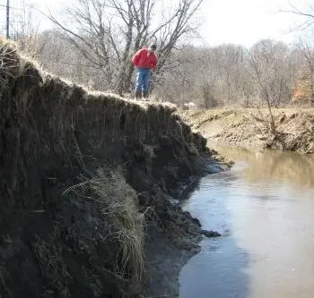 State Geologist & Director of Iowa Geological Survey surveys severe erosion on Walnut Creek