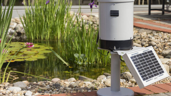 KISTERS RainTrak rain gauge station equipped with data logger & solar panel, ideal for remote sites.